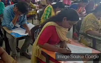 indian students giving exam in examination room