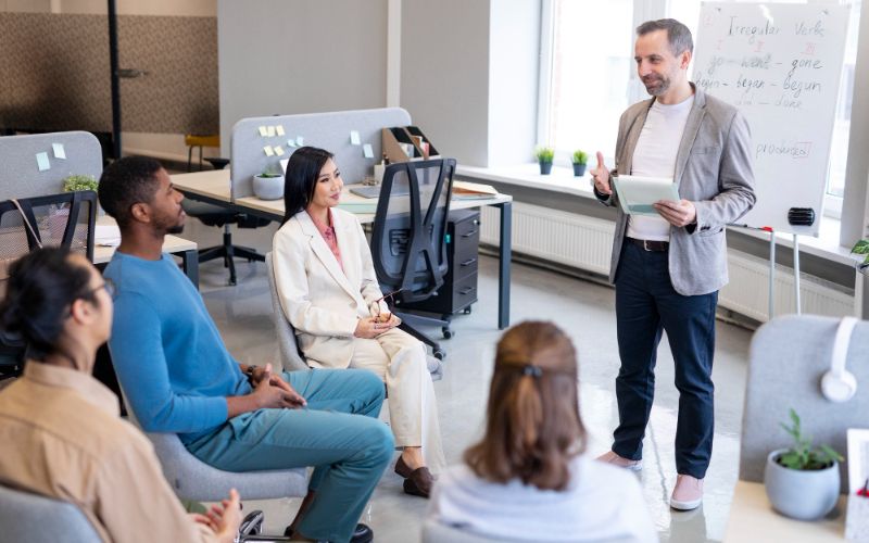 a group of people sitting in a personality development class