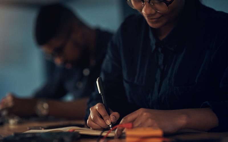 a person writing on a book