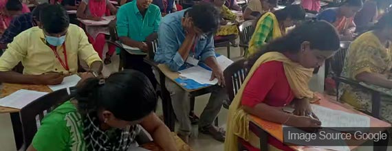 indian students giving exam in examination room