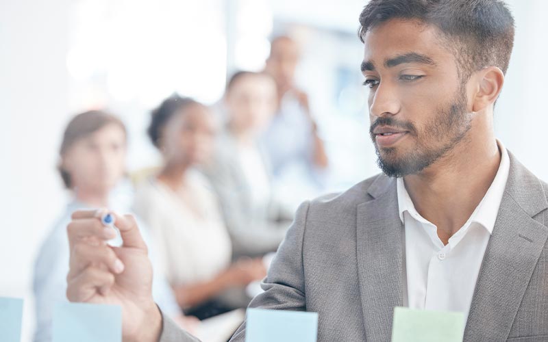 a man in a suit examining a document intently