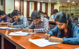 Students in classroom writing papers